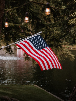 USA flag showing by lake with lights mobile size