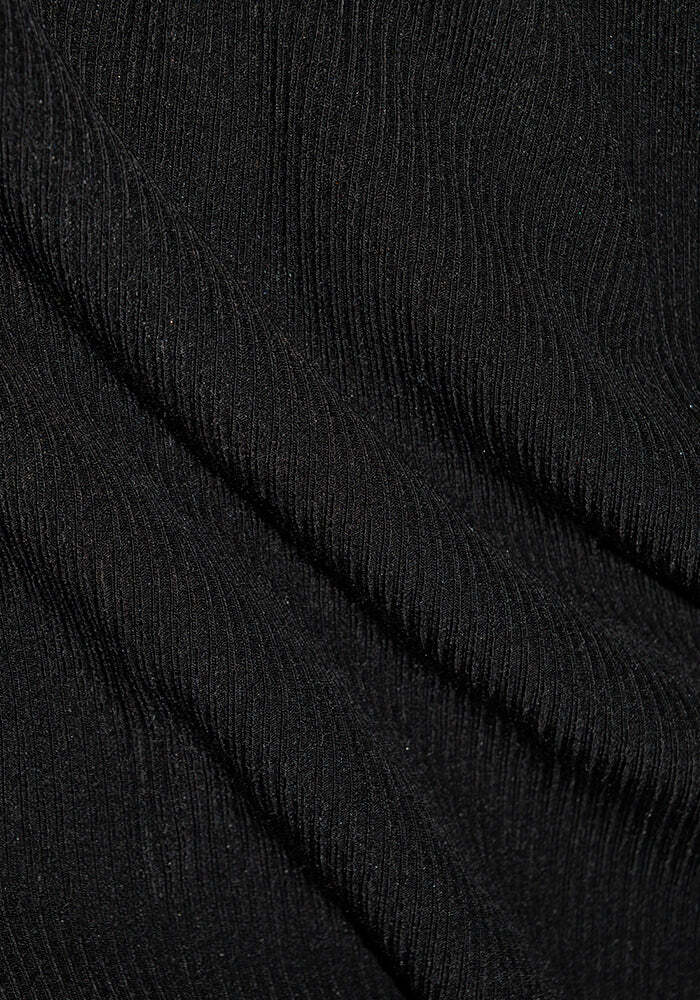 Close-up of a black, ribbed Merino wool fabric with horizontal textured lines. The material is slightly wrinkled, creating shadows and highlights that accentuate the vertical patterns and texture, perfect for an athleisure look or a stylish Woolx Quinn 1/4 Zip.