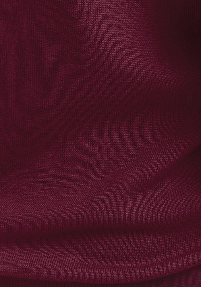 Close-up of the Cabernet Crush textured fabric of the Francesca Sweater by Woolx, showcasing visible vertical and horizontal thread patterns that create a subtle wave-like effect.