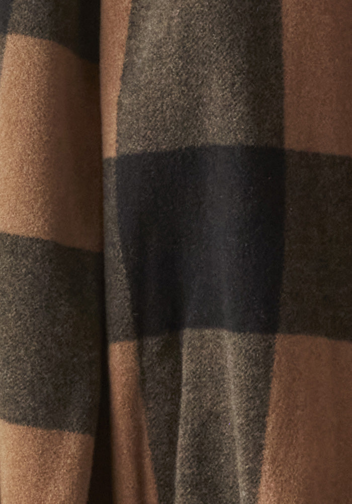 Close-up image of a fabric featuring a large plaid design with wide black and brown stripes. The texture appears soft and wool-like, suggesting it might be part of a Woolx Sawyer Shacket - Camel Checkered.