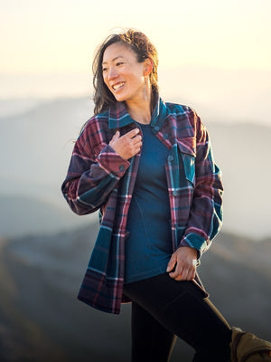 Model standing on mountain wearing heavy baselayers and Sawyer shacket mobile size