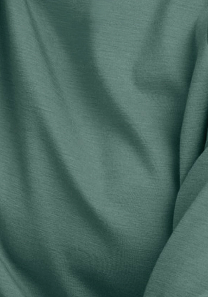 Close-up of a soft, green fabric with subtle folds and a smooth texture, reminiscent of the luxurious Parker Sweatpants - Duck Green by Woolx.