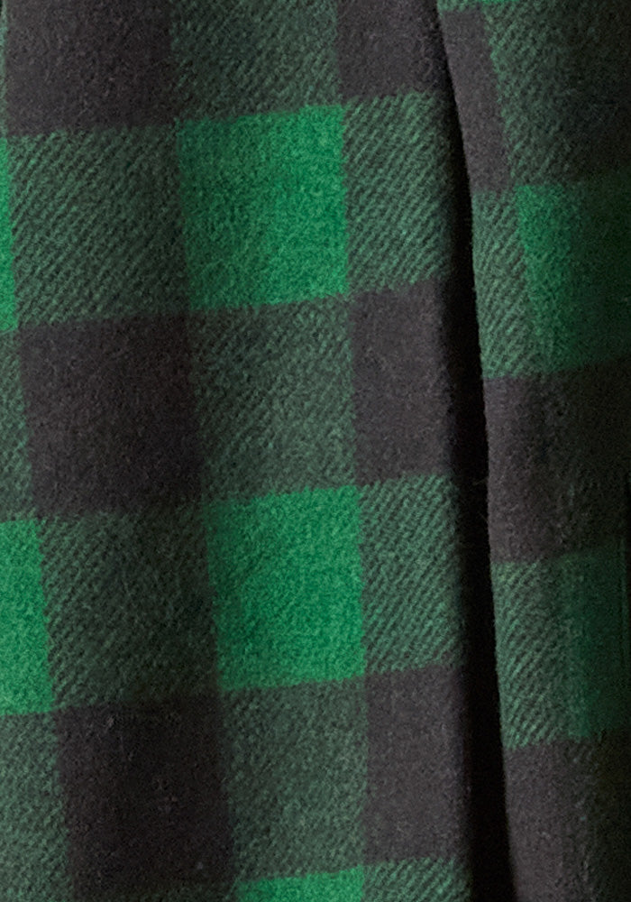 A close-up of a fabric pattern highlights the ultra-heavyweight, super-soft boucle Merino, featuring a green and black checkered design reminiscent of the Woolx Burlington Jacket in Green Black Plaid.