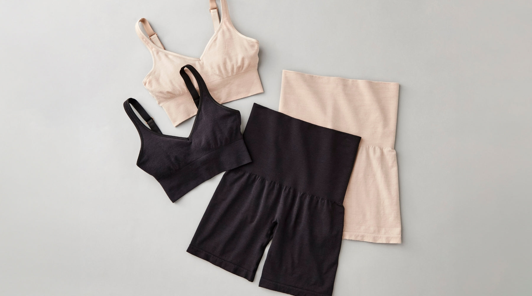 Flatlay image of Marley shapewear shorts and Hayden seamless bra in sand and black colors