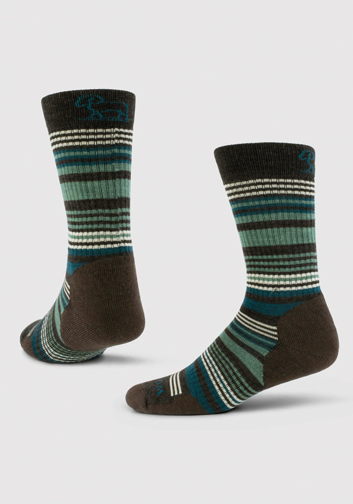 A pair of Everyday Crew Socks Light Cushion - French Roast Stripe by Woolx, crafted from merino wool. These odor-resistant crew-length socks feature dark green, teal, brown, and white stripes against a plain background. They stand upright to highlight their design and naturally temperature-regulating properties.