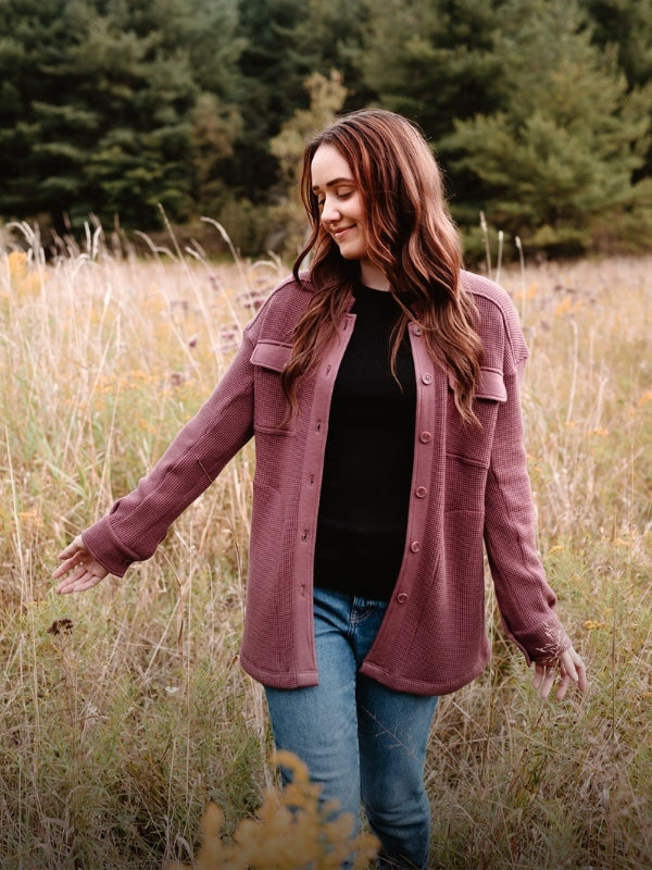 Model wearing new Oaklynn shacket in wild ginger color while standing in field