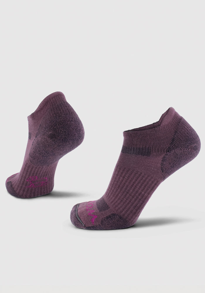 Two Rowan No Show Tab Lightweight Socks from Woolx in Wild Ginger are displayed against a white background. Made from breathable Merino wool, they feature ribbed cuffs and a textured pattern on the heel and toe area, providing both comfort and durability.