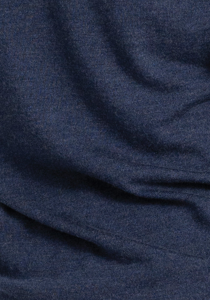 Close-up of the Francesca Sweater by Woolx in dark navy blue, showcasing its subtle texture and soft folds.