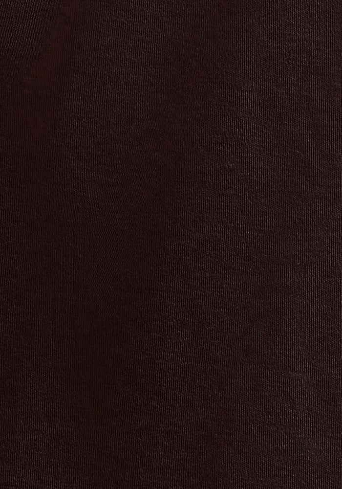 Close-up of the Eva Tunic - French Roast by Woolx, featuring a dark brown textured fabric surface with a subtle weave pattern reminiscent of fine Merino wool. The image offers a detailed view of its fibers and material composition, emphasizing the intricate details that highlight the uniformity and texture, making it ideal for crafting stylish tunics.