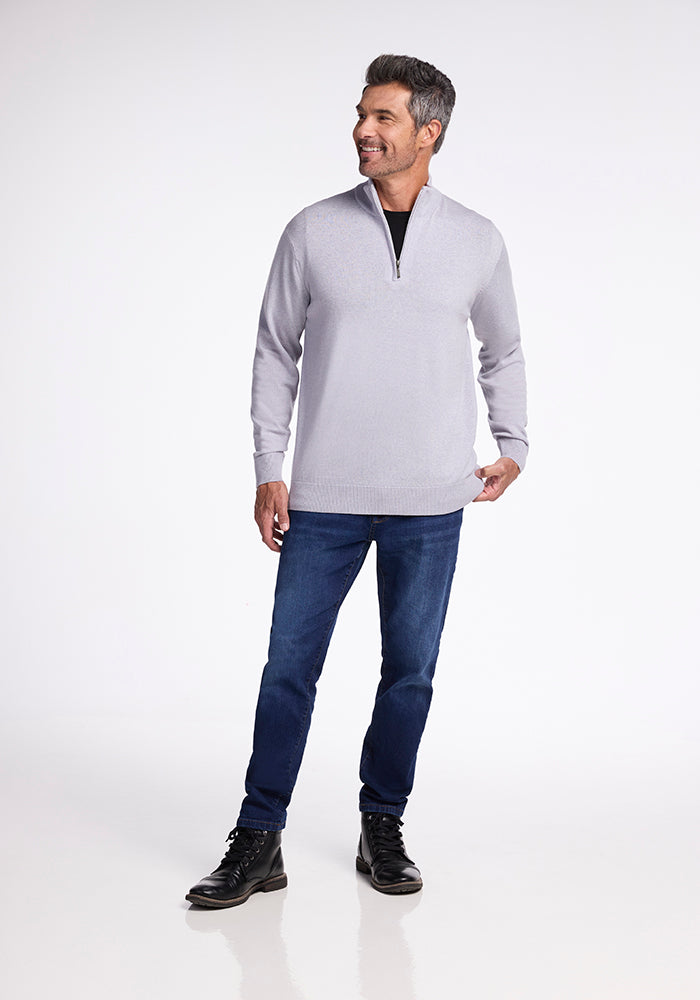 A man in an Enzo Quarter Zip - Mist sweater by Woolx and jeans.