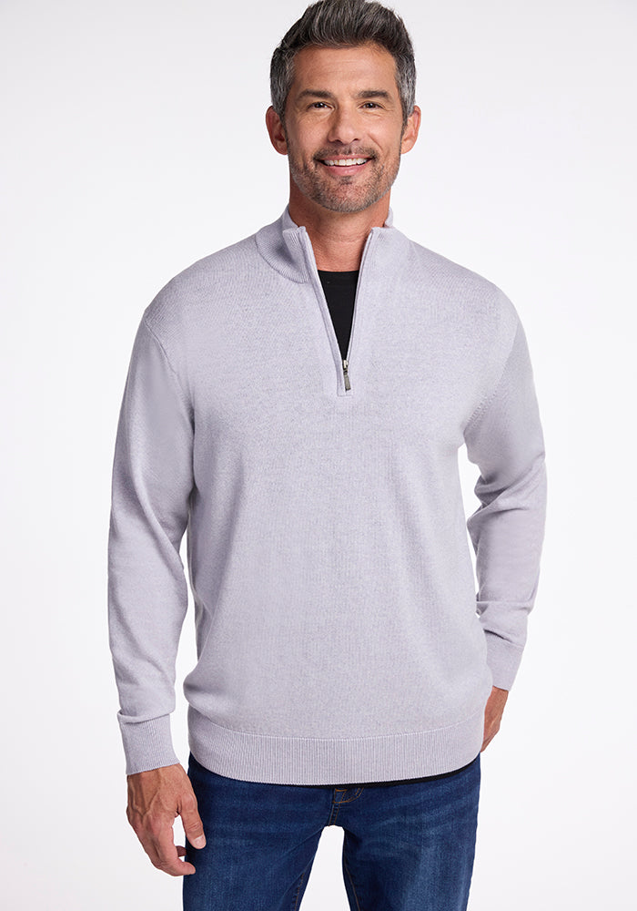 A man wearing the Enzo Quarter Zip - Mist sweater by Woolx. 