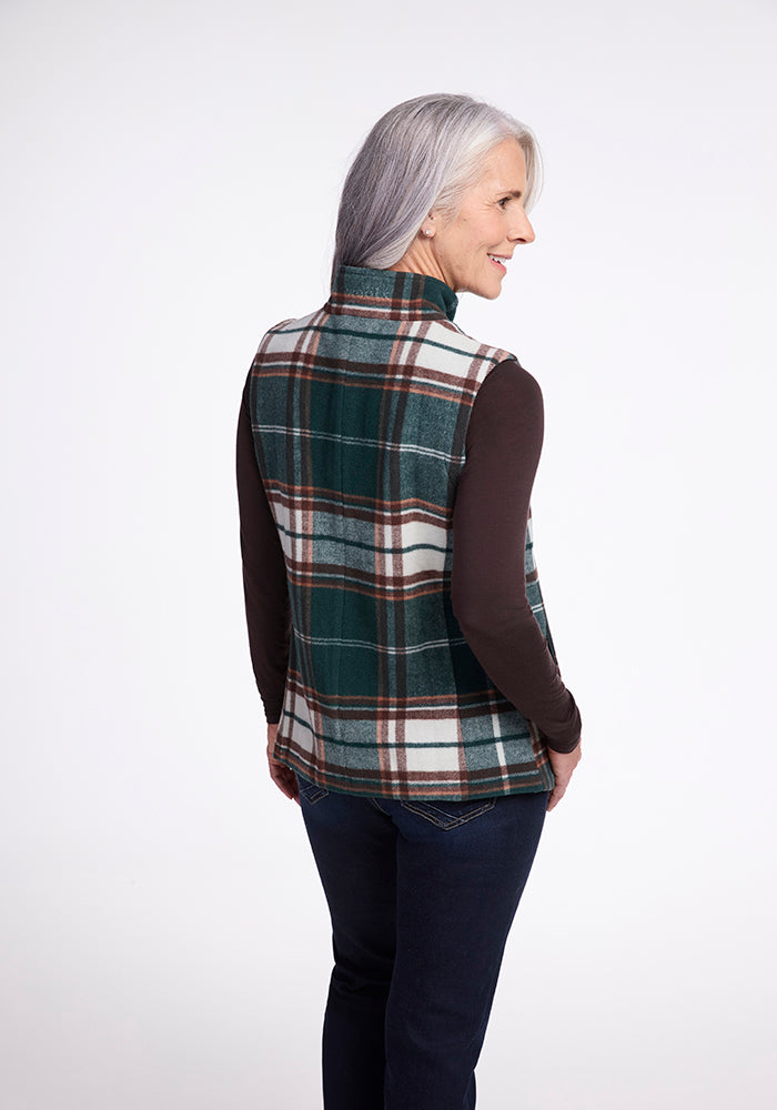 A person with long gray hair is standing and facing away from the camera. They are wearing the Colbie Vest - Espresso Plaid by Woolx over a dark brown long-sleeve shirt and dark blue jeans, set against a plain white background.