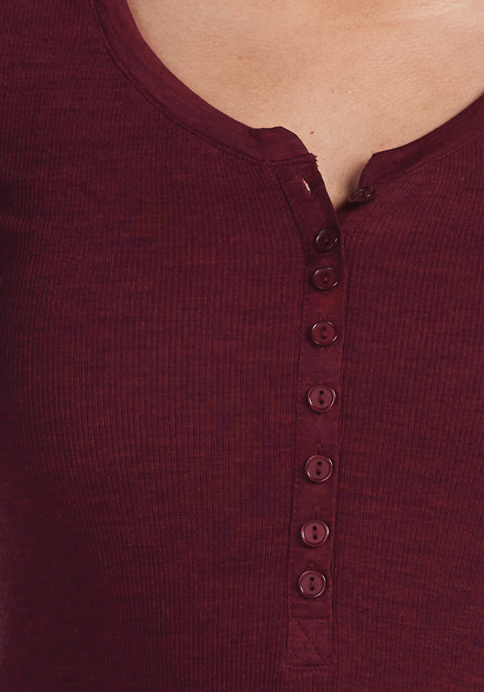 Close-up of an individual donning the Reese Ribbed Henley in Cranberry Melange by Woolx, crafted from moisture-wicking fabric and featuring front buttons.