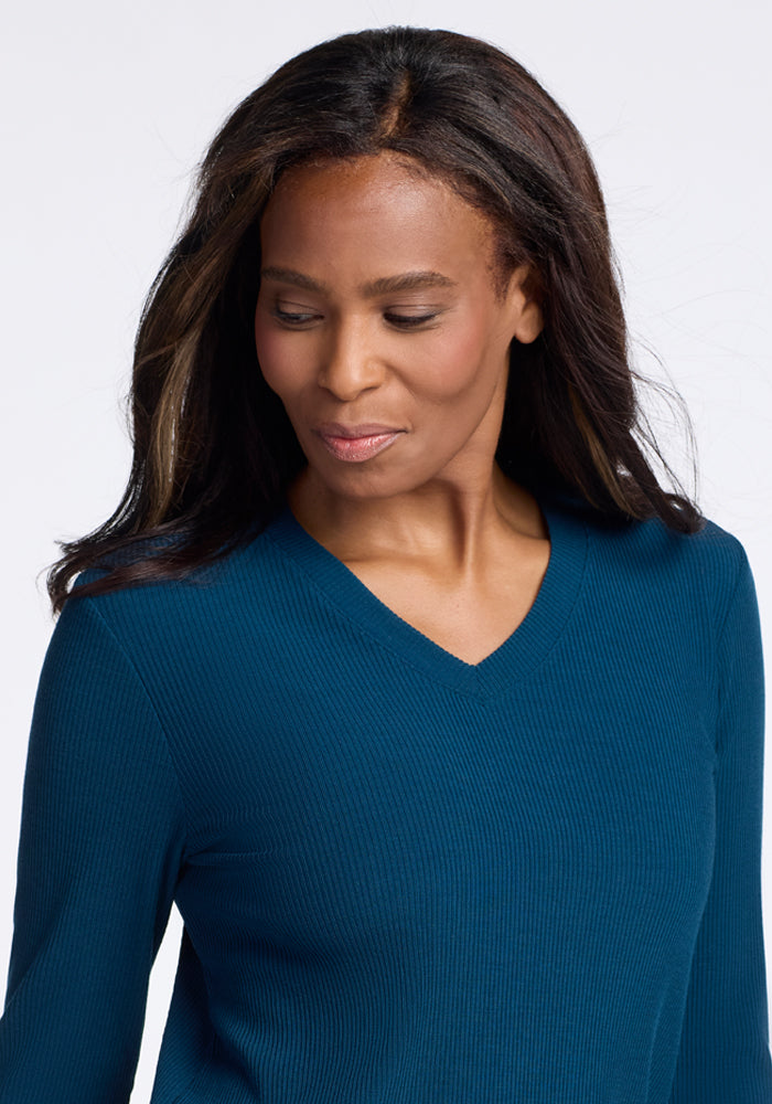 Model wearing real teal merino wool v neck sweater