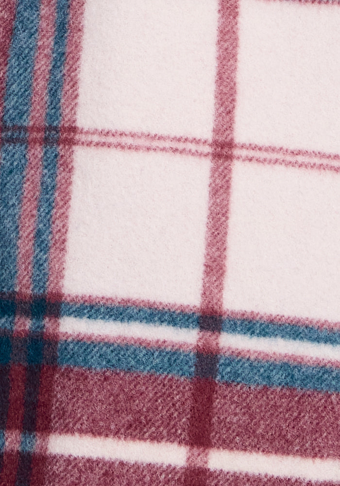 Close-up of a Woolx Sawyer Shacket displaying a plaid design with intersecting lines in burgundy, teal, and white. The fabric looks soft and cozy, likely made from warm flannel material.