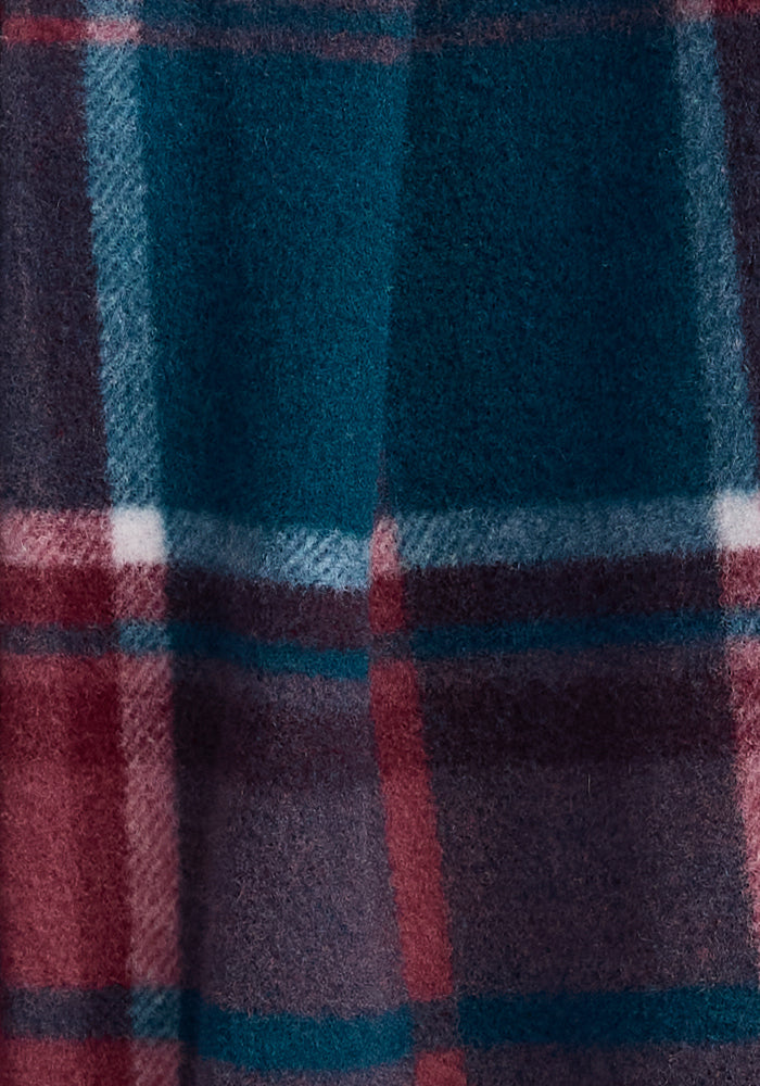 Close-up of the Sawyer Shacket by Woolx, showcasing its soft and fuzzy woolen fabric with a plaid design. The large squares feature shades of dark green, maroon, blue, and white.