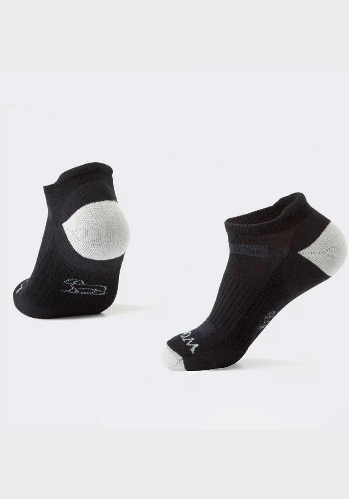 The Tempo Ankle Socks Full Cushion - Black by Woolx, made from Merino wool, are displayed against a plain white background. These black socks with gray accents on the heel and toe feature a subtle logo on the side, making them ideal for hiking and other outdoor activities.