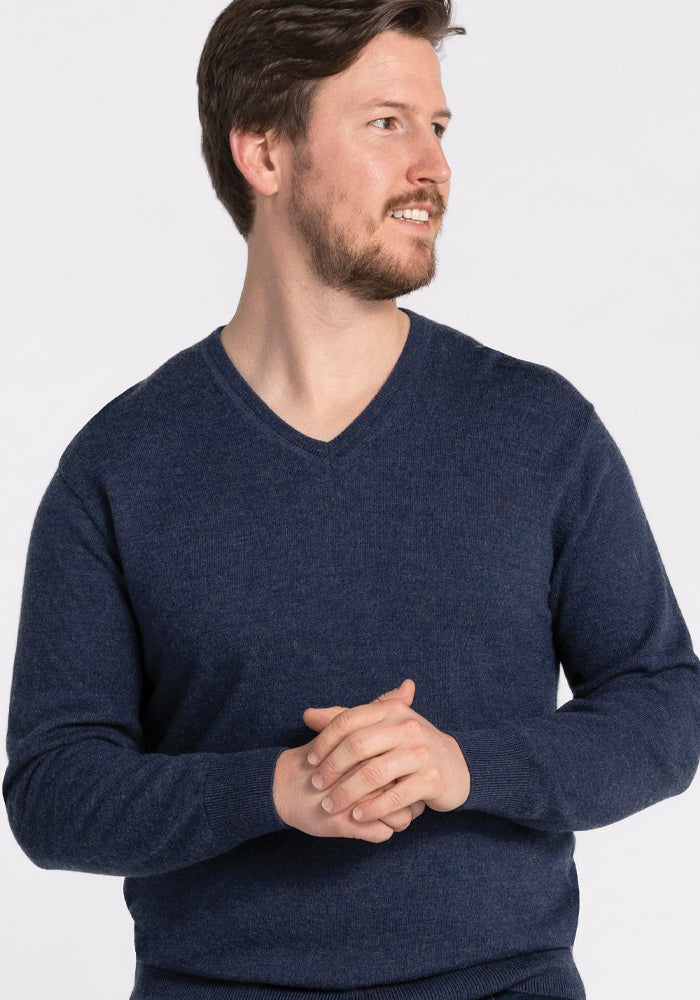 A man wearing a Vincenzo Sweater in the Twilight Storm shade by Woolx.