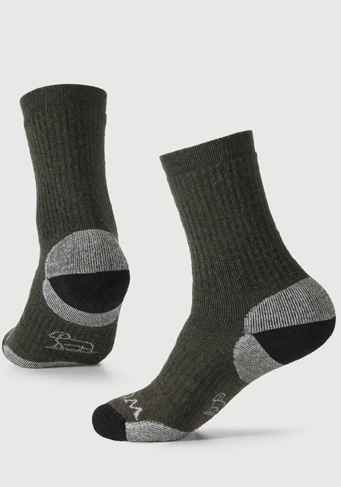 Displayed are two Core Crew Socks Full Cushion in the "Deep Forest" color by Woolx. One sock highlights the heel and sole design, made from Merino wool for premium comfort, while the other showcases its front and top. Positioned at an angle, they emphasize their moisture-wicking properties and texture.