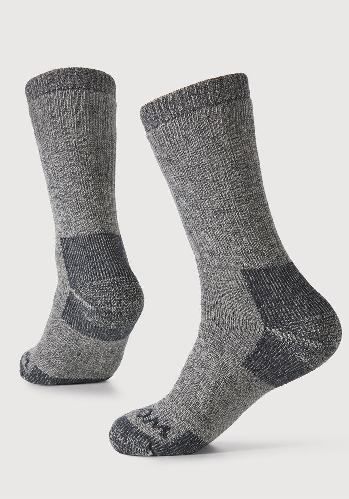 A pair of Extreme Full Cushion Crew Socks in Charcoal Heather by Woolx is displayed against a plain white background. These socks look thick and warm, providing exceptional warmth, making them ideal for cold weather.