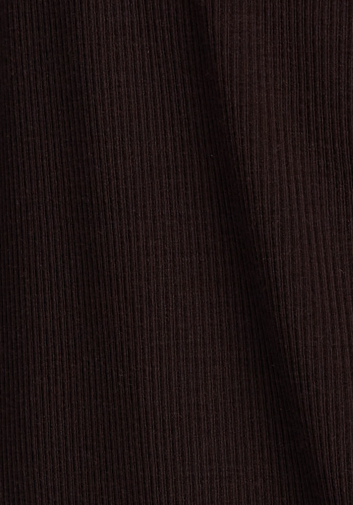 Close-up of a dark brown ribbed fabric, with the vertical texture of the material clearly visible. The fabric surface is consistent and slightly undulated, giving a sense of depth and softness. This versatile style would be perfect for an Ainsley Sweater - French Roast made from luxurious Merino wool by Woolx.