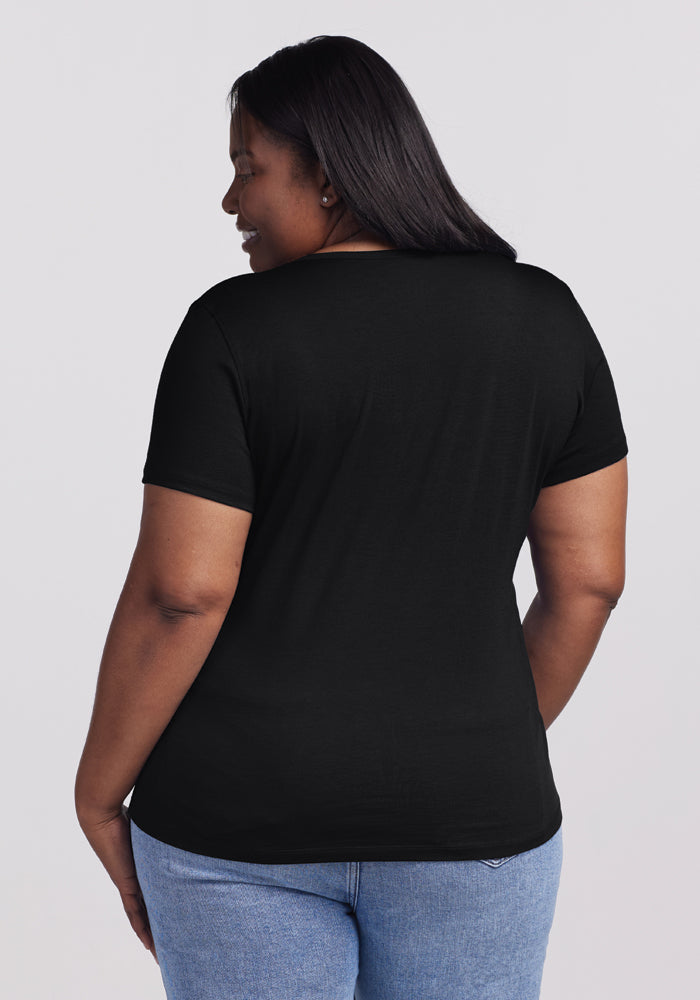 In the Women's Liza Crew Neck Tee from Woolx, crafted with moisture-wicking fabric, a woman stays comfortably chic.